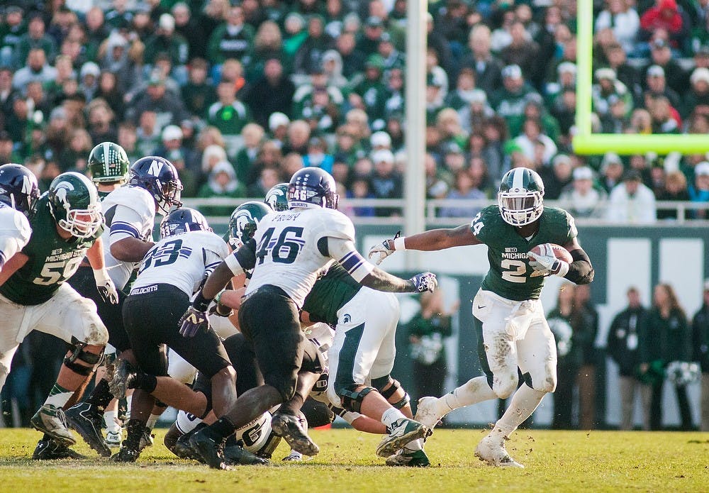 	<p>Junior running back Le&#8217;Veon Bell escapes Northwestern&#8217;s defenders on Saturday, Nov. 17, 2012, at Spartan Stadium. Bell contributed 133 rushing yards in the Spartans&#8217; 23-20 loss to Northwestern. James Ristau/The State News</p>