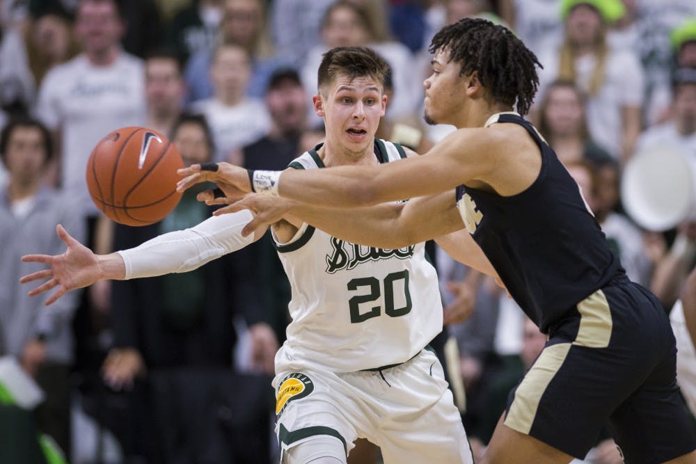 Senior guard Matt McQuaid (20) covers Purdue guard Carsen Edwards (3) during the first half of the men's basketball game against Purdue on Jan. 8, 2018 at Breslin Center. The Spartans led the first half, 39-26.