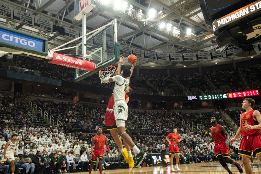 <p>Michigan State&#x27;s senior forward Marcus Bingham Jr. jumps to dunk the ball during Michigan State&#x27;s victory over Ferris State on Oct. 27, 2021</p>