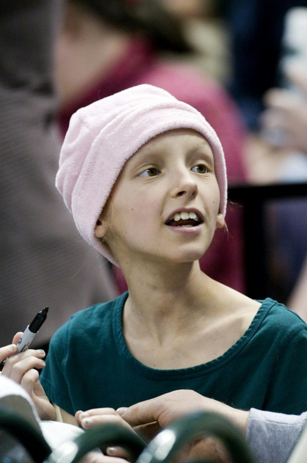 Mariah Mackie, 10, watches the women's basketball game vs. Purdue Sunday night at the Breslin Center. Mackie, a child battling cancer, is this week's kid of inspiration, a program started by the MSU Children's Health Initiative. Derek Berggren/The State News