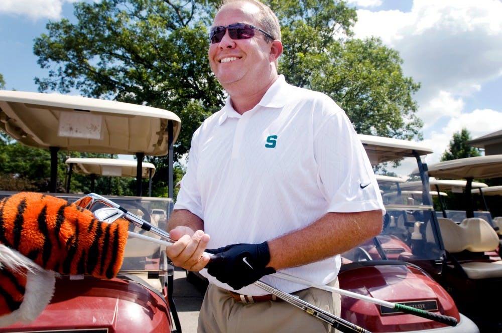 	<p>Mark Hollis, <span class="caps">MSU</span>&#8217;s athletic director, grabs his clubs and heads to the driving range in 2011 for a golf outing with University of Michigan athletic director Dave Brandon. Hollis told <span class="caps">ESPN</span>.com Thursday that he has received commitments from 16 collegiate men’s basketball teams to compete in a tournament in Portland, Ore. in November 2017 to celebrate the 80th birthday of Nike co-founder, Phil Knight.</p>