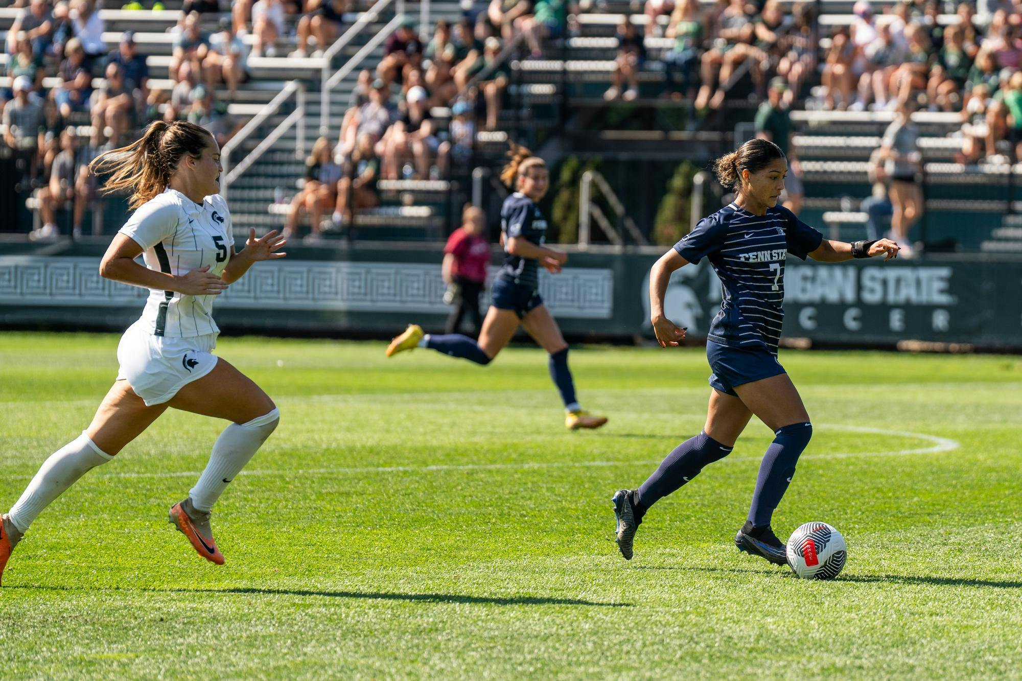 <p>MSU senior midfielder Regan Dalton (5) chases Pennsylvania State University Sophomore forward Amelia White (7) at DeMartin Soccer Stadium on Oct. 1, 2023.</p>