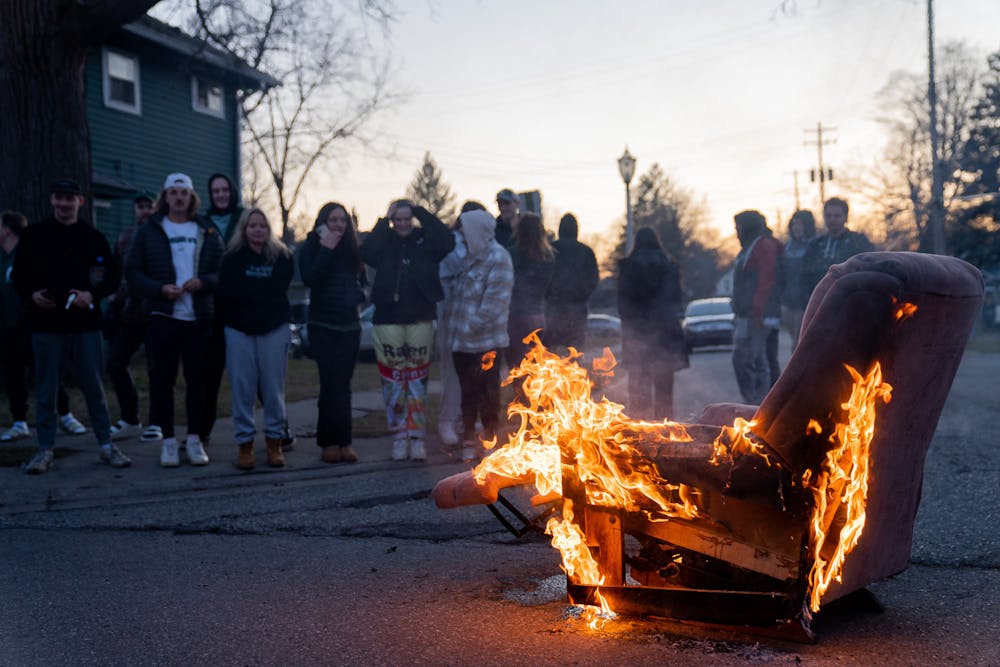 A couch burns in Beal Street, East Lansing after Michigan State University defeated Marquette University in the NCAA men’s basketball March Madness tournament, on March 19, 2023. The win secured the Spartans a spot in the Sweet Sixteen for the tournament. 