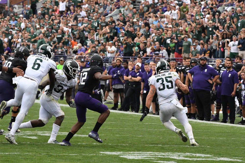 <p>Senior linebacker Joe Bachie runs following an interception during the game against Northwestern on Sept. 21, 2019 at Ryan Field. MSU defeated Northwestern, 31-10.</p>