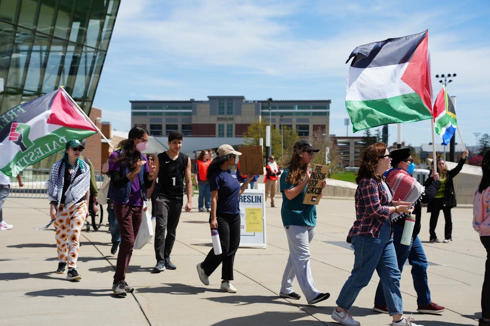 Protestors march at the MSU Breslin Center on April 26, 2024. They demanded that the university divest from Israel, chanting "Not another nickel, not another dime, no more money for Israel's crimes."
