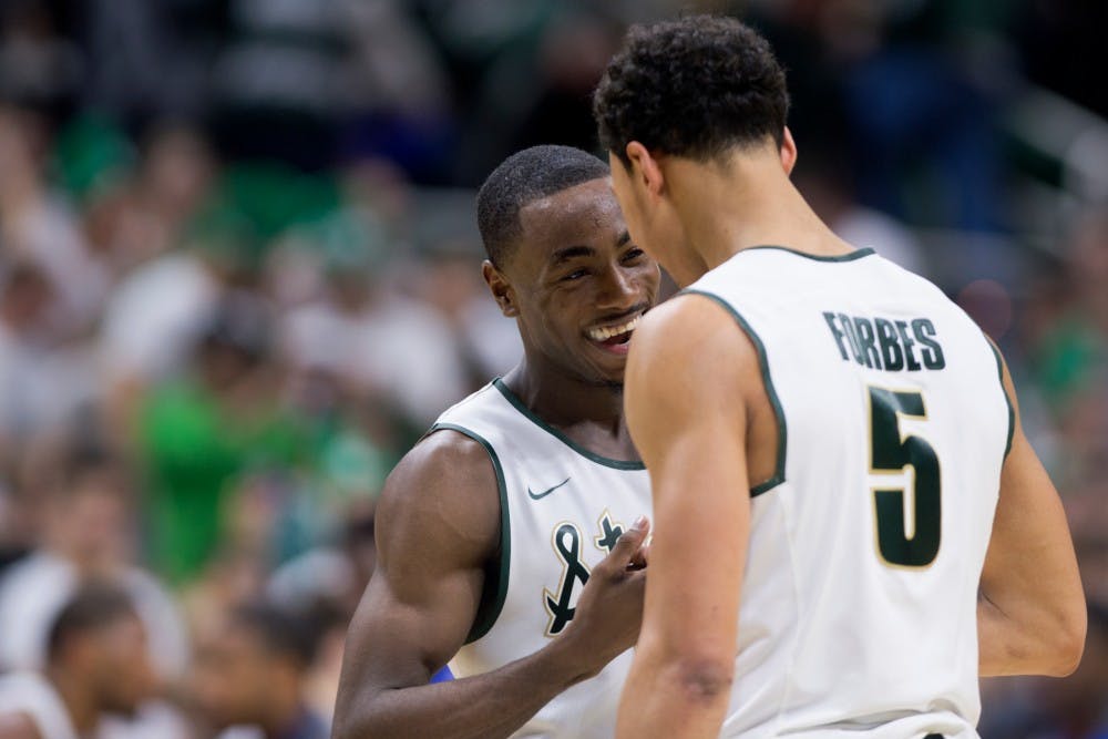 Sophomore guard Lourawls 'Tum Tum' Nairn Jr. celebrates with senior guard Bryn Forbes on Dec. 12, 2015 after the game against Florida at Breslin Center. The Spartans defeated the Gators, 58-52.