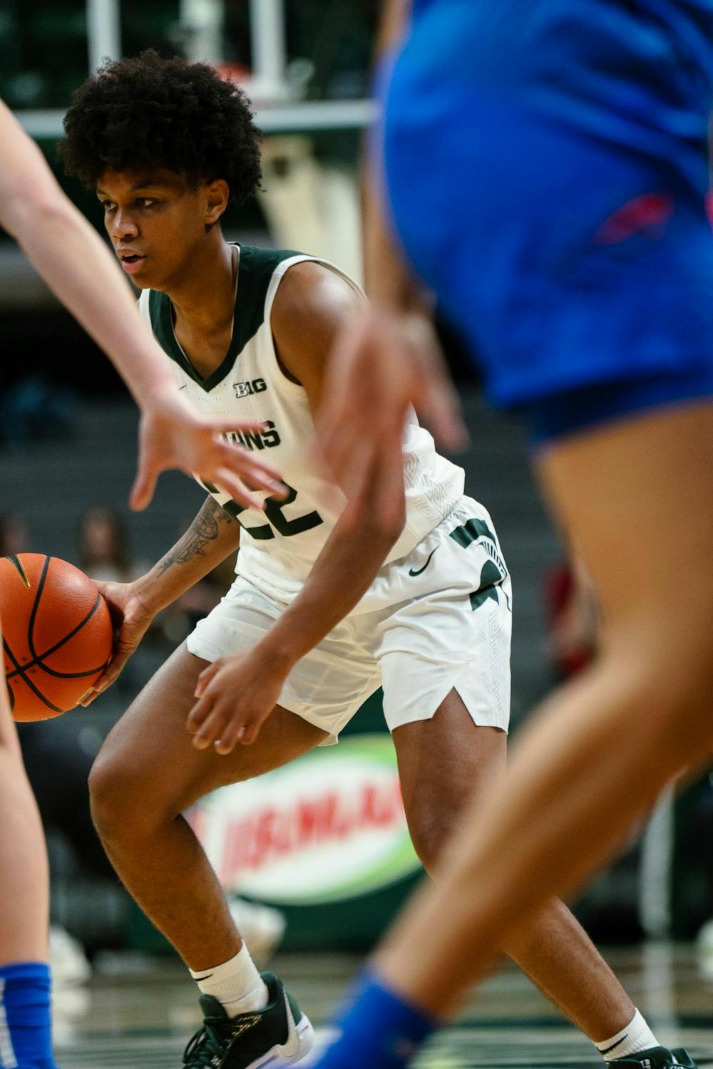 Michigan State graduate student guard Nyla Hampton (22) searches for a teammate to pass to at the Breslin Center on Dec. 8, 2024. The Spartans won 89-61 against the Blue Demons from DePaul University, starting the season 9-0 for the first time in program history. 