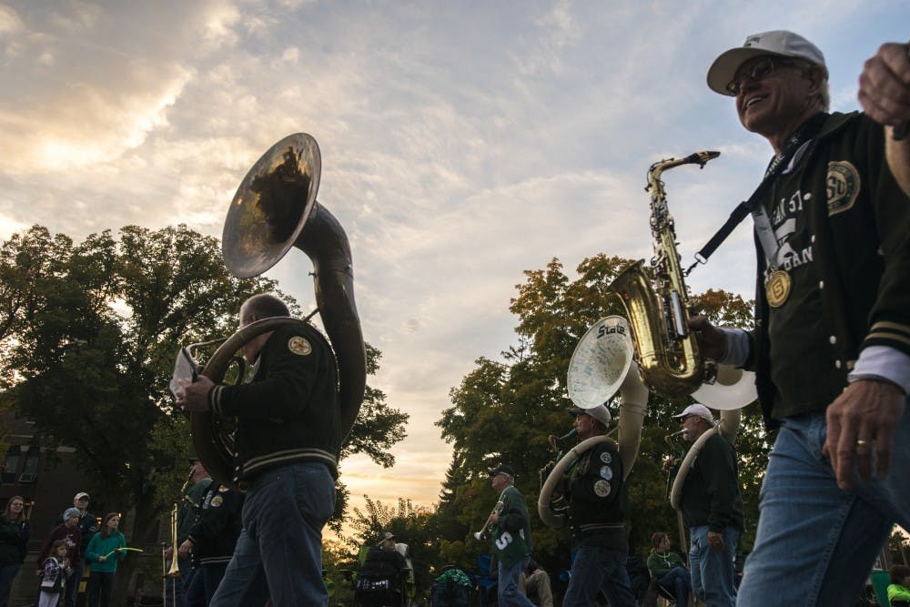 Spartan marching band alumni walk during the homecoming parade on Oct. 14, 2016 on Abbot Road. 