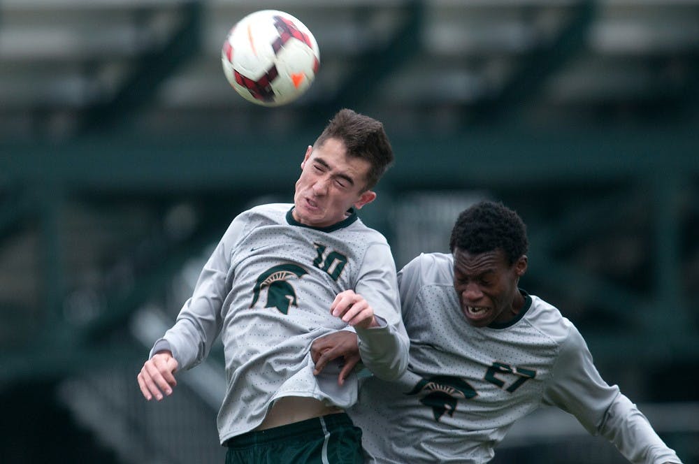 	<p>Sophomore midfielder Jay Chapman, left, and junior midfielder Fatai Alashe go up for a header on Nov. 5, 2013, during the game against Notre Dame at DeMartin Stadium at Old College Field. The Spartans lost to the Fighting Irish, 2-0. Julia Nagy/The State News</p>