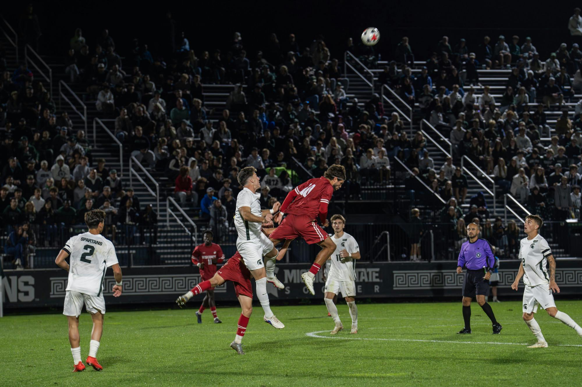 <p>Michigan State junior defender Brandon Munson (5) challenges two Wisconsin attackers in the air for the ball at DeMartin Stadium in East Lansing, Mich., on Friday, Sept. 25, 2026.</p>