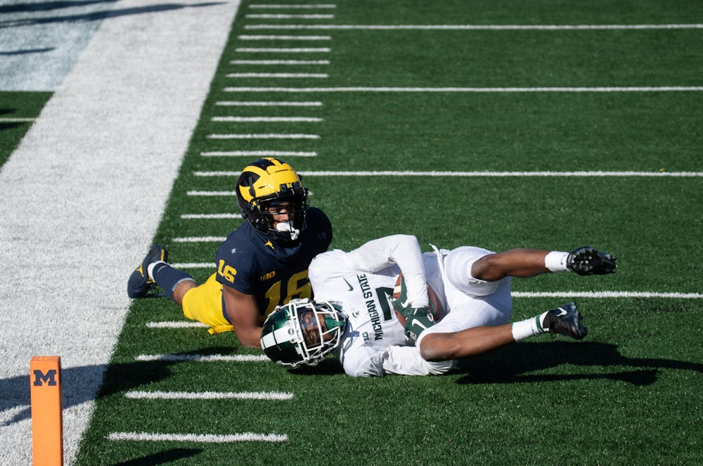 <p>Wide reciever Ricky White (7)) catches a pass from Rocky Lombardi on Oct 31, 2020 in Ann Arbor, MI.</p>