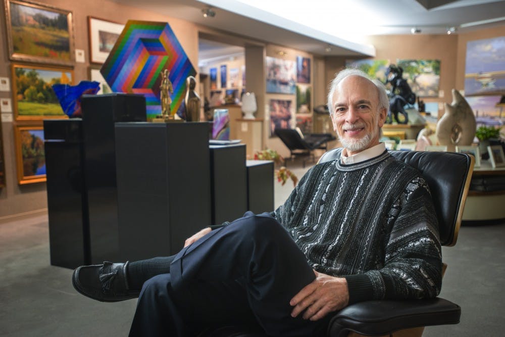 East Lansing resident Roy Saper poses for a portrait on Dec. 6, 2016 inside of Saper Galleries and Custom Framing at 433 Albert Ave. Saper opened his gallery in 1978 and said, "Saper Galleries provides a resource for everyone who might have (or) who has an interest in art," and that his gallery sells art to clients all over the world.