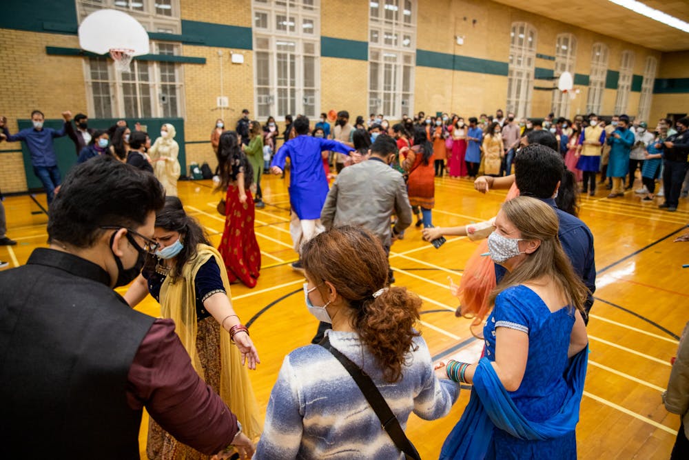 <p>People participating in Dandiya Raas, an Indian folk dance, at the Diwali celebration that was held at IM West Circle on MSU’s campus on Nov. 5, 2021. The event was put on by the Indian Student Organization at MSU in collaboration with the International Students’ Organization. </p>