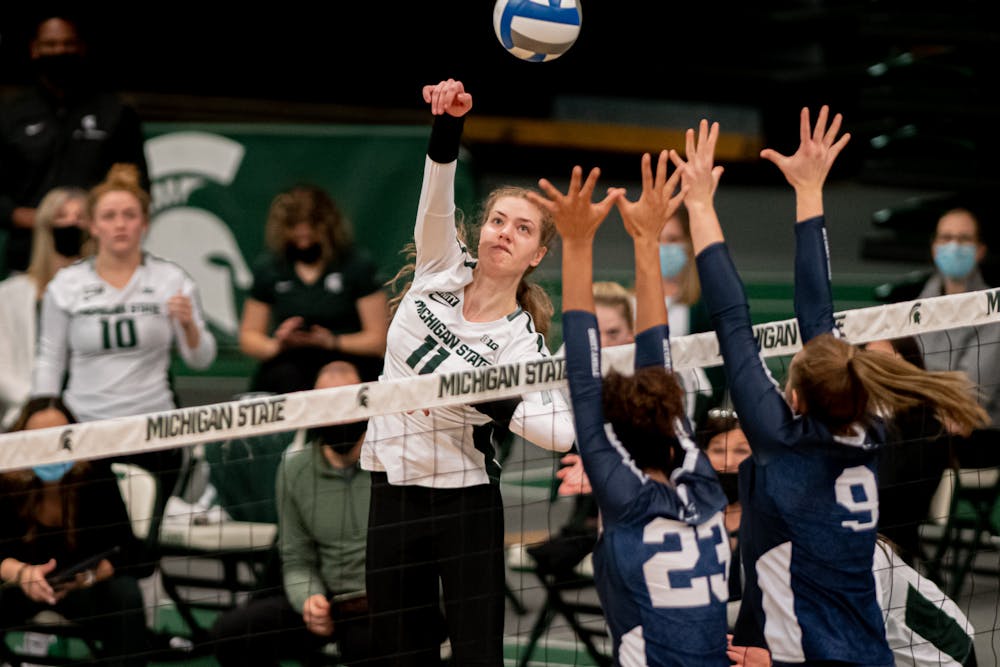 <p>Senior outside hitter Alyssa Chronowski spikes the ball over Penn State defenders during the Spartans&#x27; loss March 19, 2021. The Spartans fell in three sets.</p>