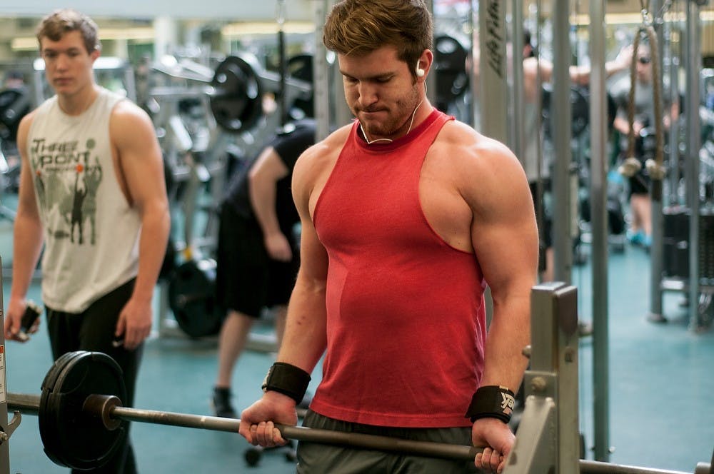 <p>Communication sophomore Drew McClellan lifts weights Dec. 3, 2014 at IM Sports-West. &quot;Working out relieves my stress from finals week,&quot; McClellan said. &quot;Just getting in the gym and working out is what counts.&quot; Raymond Williams/The State News</p>