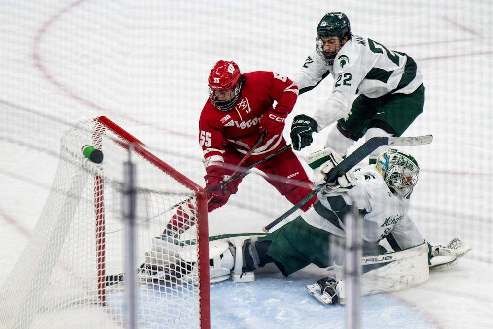 <p>Players fight for the puck during the Michigan State University verses Wisconsin Hockey game at MSU's Munn Stadium in East Lansing, Mich. on Saturday, Nov. 22, 2025.</p>