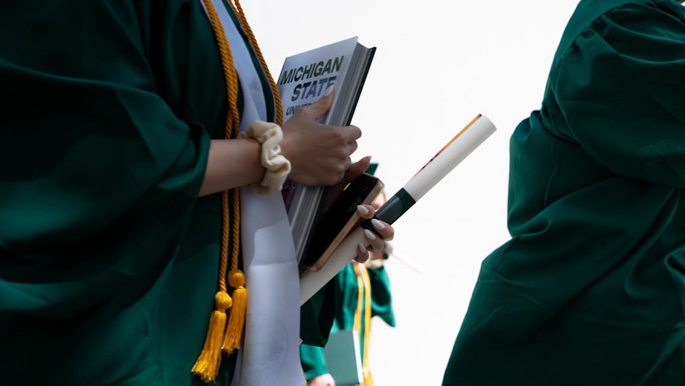 Graduates walk out of the Breslin Center tunnel after commencements on May 3, 2025.