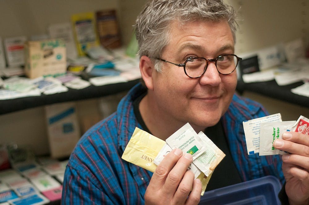 <p>MSU Planetarium Interim Director John French poses with his variety of moist towelettes on April 17, 2014, at Abrams Planetarium. French has been collecting moist towelettes since the early 1990s. He has towelettes for many uses including cleaning hands, dentures, and radioactive materials. Betsy Agosta/The State News</p>