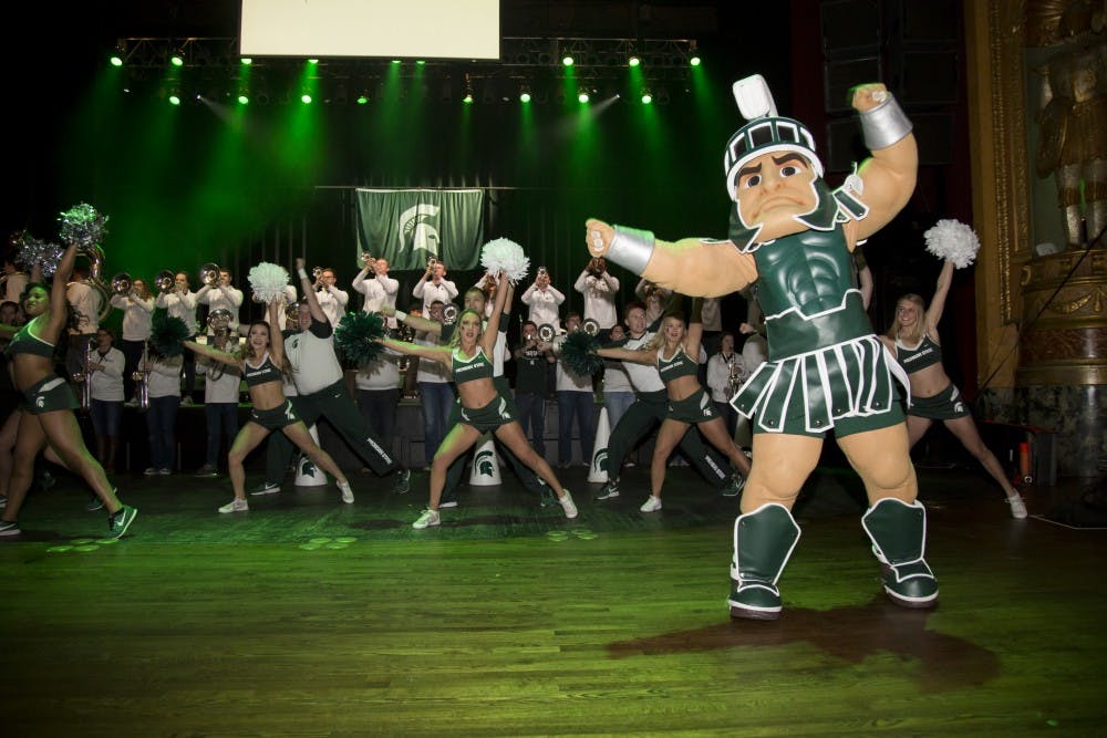 <p>Sparty dances along with the Spartan Brass and the MSU Cheer and Dance team as they perform the MSU fight song during the 2018 NCAA Spartan Pep Rally at The Fillmore in Detroit on March 16, 2018</p>