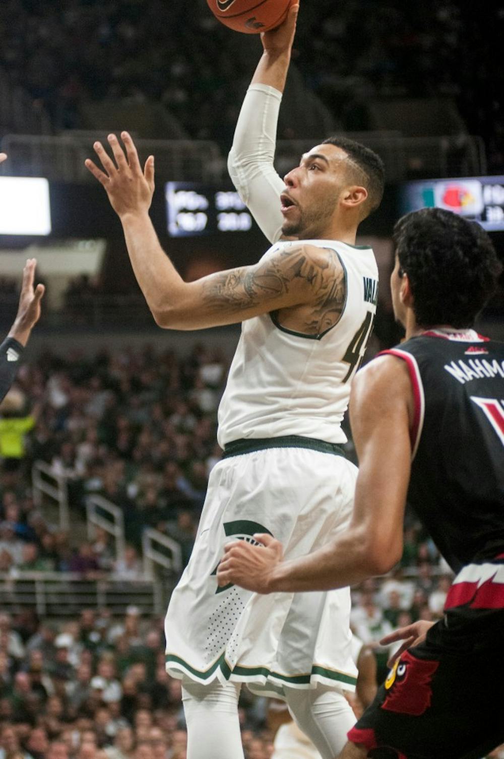 Senior guard Denzel Valentine, 45, shoots during the first half of the basketball game against the University of Louisville on Dec. 2, 2015 at the Breslin Center in East Lansing, MI. The Spartans defeated the Cardinals, 71-67.