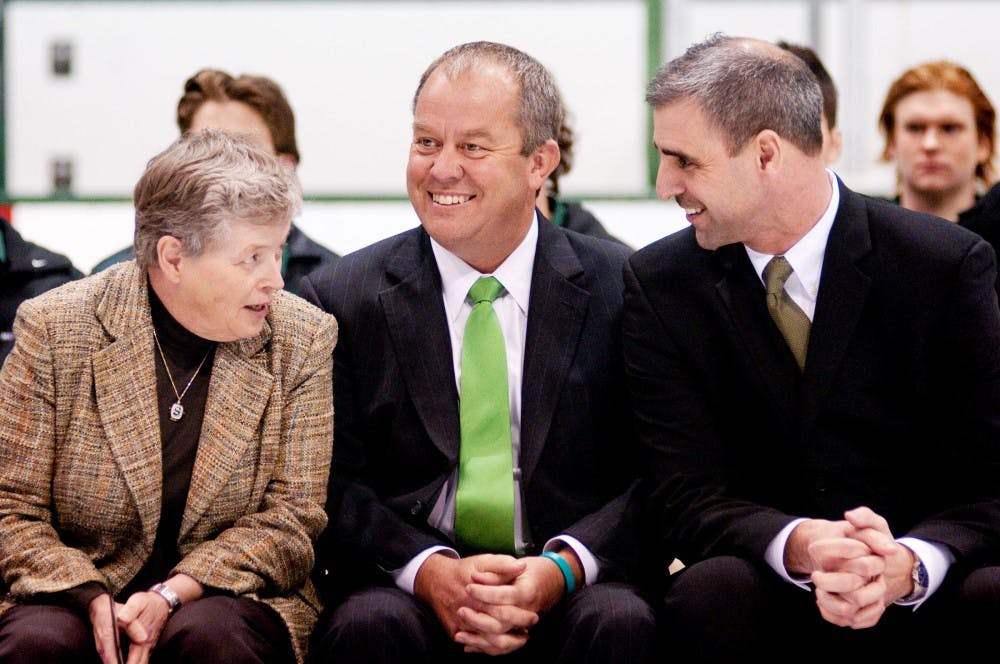 From left, President Lou Anna K. Simon, Athletic Director Mark Hollis, and the hockey program's new head coach Tom Anastos all have a laugh during the press conference announcing Anastos' hiring on Wednesday afternoon at Munn Ice Arena. ?In my mind I made my decision and he?s the only person I offered the job to," Hollis said.  Josh Radtke/The State News