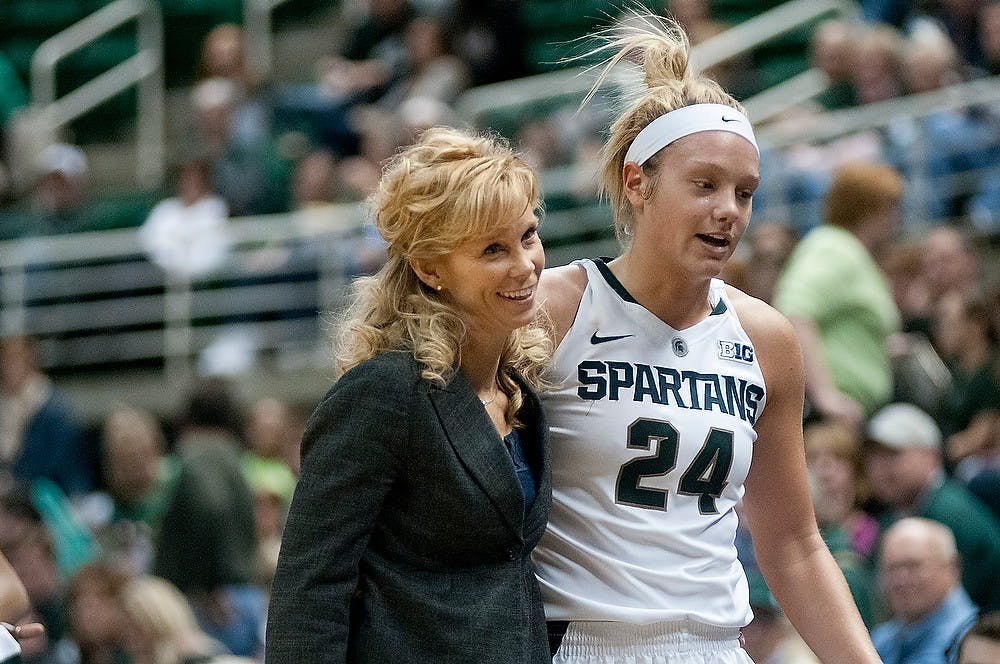 	<p>Head coach Suzy Merchant walks with senior forward Courtney Schiffauer on Saturday, Dec. 1, 2012, during the game against Wisconsin-Milwaukee at Breslin Center after Schiffauer was injured. The Spartans beat the Panthers 81-50. Julia Nagy/The State News</p>