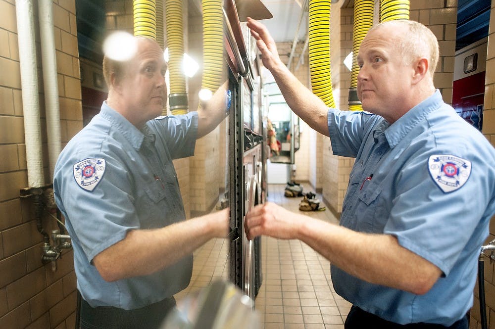 	<p>Firefighter paramedic Josh Barrett checks the equipment on the side of a fire truck, Wednesday, Feb. 20, 2013, at East Lansing Fire Station 2, 208 W. Shaw Lane. Daily routine for firefighters include a regular equipment check and clean up every morning. </p>