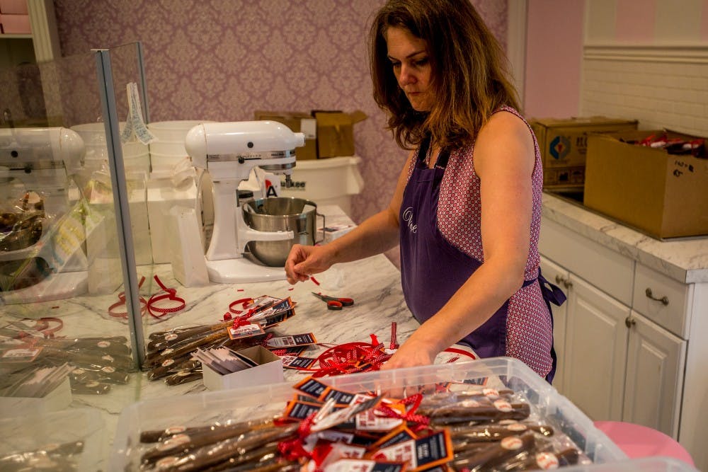 Trish Berakovich prepares chocolate covered pretzels decorated like baseball bats on June 8, 2016 at Velvet A Candy Store at 507 E. Grand River Ave. 