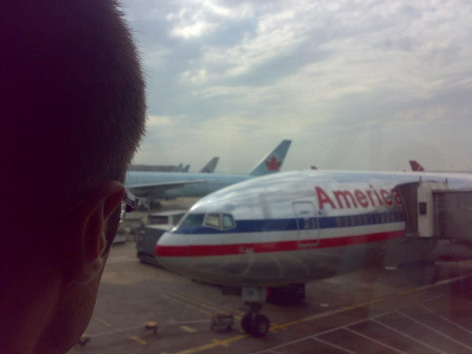 Amin Ghorbanpour looks out the window at London's Heathrow Airport in 2012 as he awaits his connecting flight to come to the U.S. for the first time. Ghorbanpour's parents are now prevented from visiting him in the States under a travel ban upheld by the Supreme Court in June. Photo courtesy of Amin Ghorbanpour.