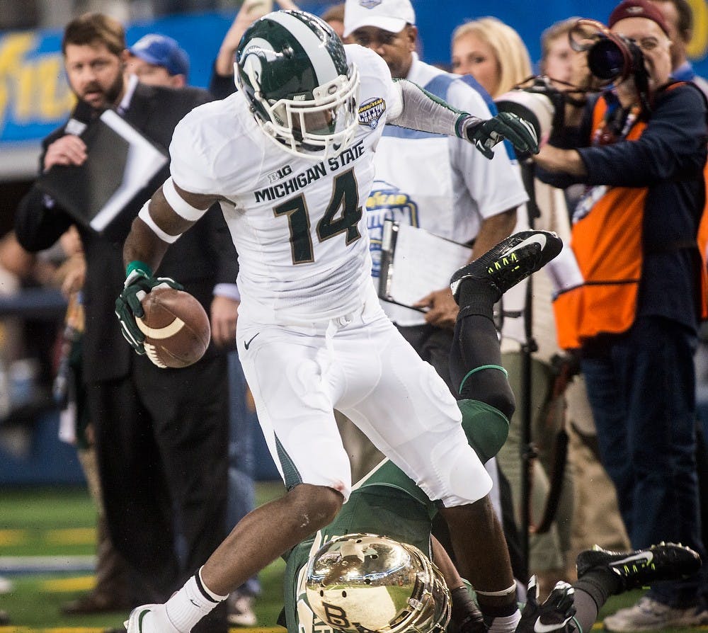<p>Senior wide reciever Tony Lippett runs the ball down the field past Baylor defense Jan. 1, 2015, during The Cotton Bowl Classic football game against Baylor at AT&T Stadium in Arlington, Texas. The Spartans defeated the Bears and claimed the Cotton Bowl Victory, 42-41. Erin Hampton/The State News</p>