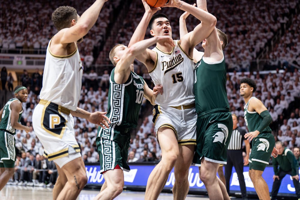 <p>Purdue's junior center Zach Edey (15) attempts to score as his MSU opponents guard him during a game against Purdue at Mackey Arena on Jan. 29, 2023. The Spartans lost to the Boilermakers 77-61.</p>