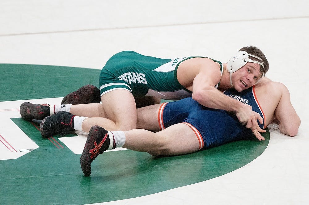 	<p>Senior 157-pounder David Cheza and Bucknell Bison Vincent Favia wrestle Jan. 6, 2013, at Jenison Field House. Cheza had four takedowns in the match. Julia Nagy/The State News</p>