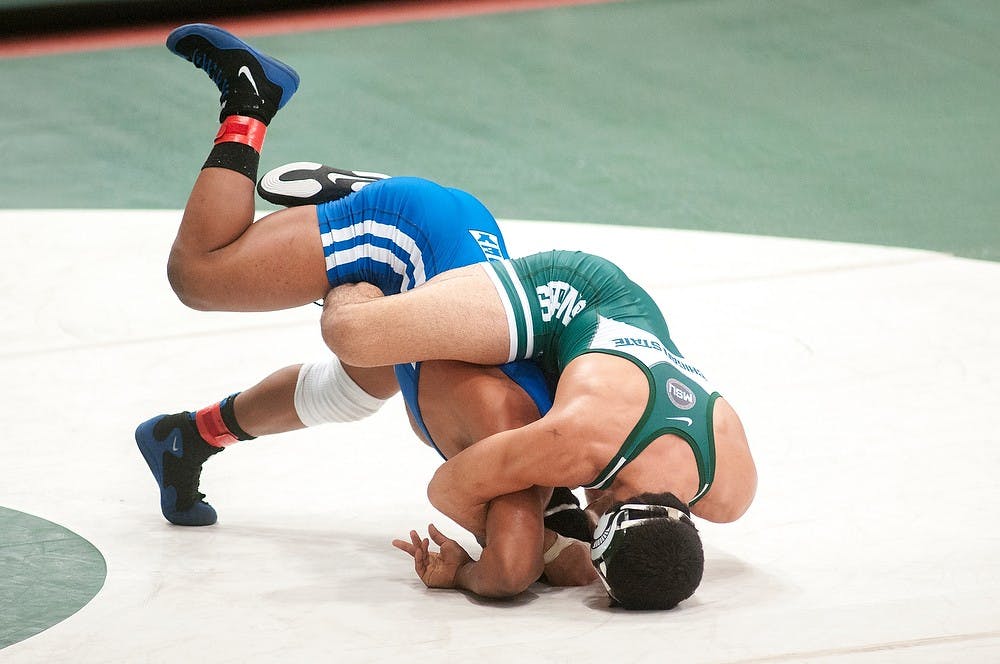 	<p>Junior Mike McClure grapples Theodore Furnish of Lindsey Wilson College on Sunday, Nov. 11, 2012, at Jenison Fieldhouse. The two were competing in the Michigan State Open wrestling tournament. James Ristau/The State News</p>