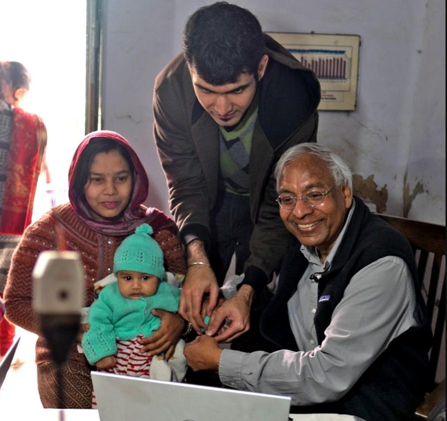 <p>MSU Biometrics Research Group leader and&nbsp;computer science professor Anil Jain, right, and doctoral&nbsp;student and biometrics group&nbsp;researcher Sunpreet Arora, next over,&nbsp;collect fingerprint data during&nbsp;the group's January&nbsp;research trip to India. Courtesy of MSU Biometrics Research Group.</p>