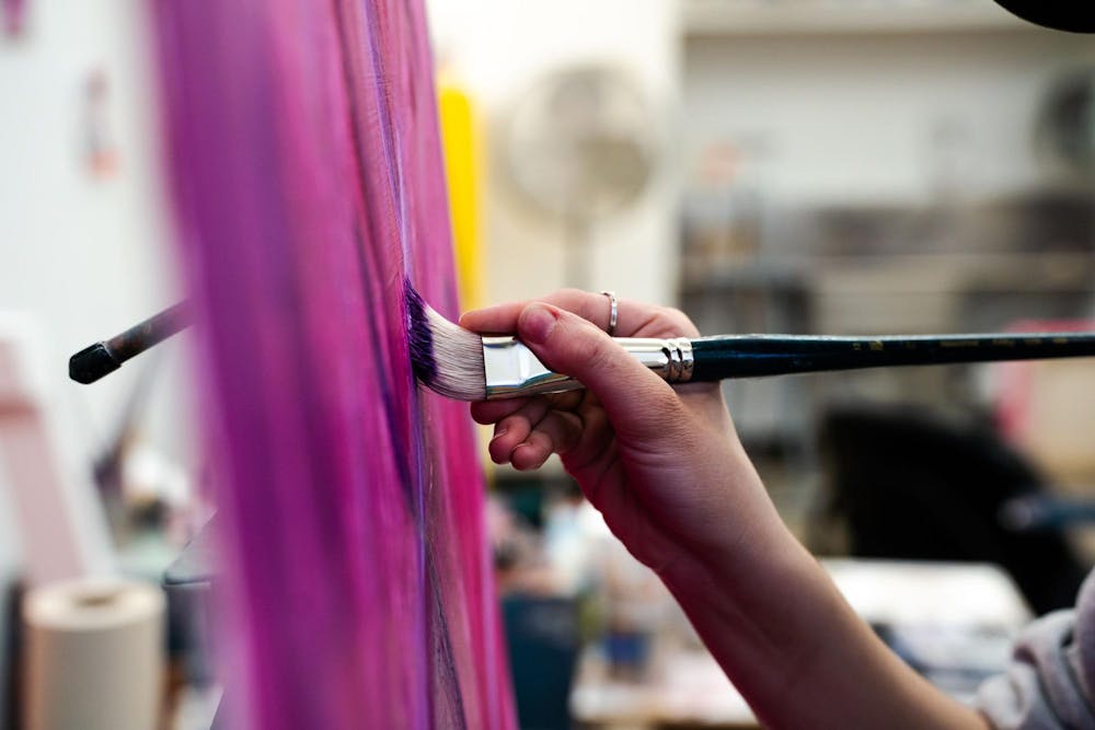 <p>Fourth-year Michigan State studio art student Evan Yalowitz paints in her studio at Kresge Art Center on April 4, 2025. “If I ever lost my hands, I would be so distraught. Because that’s how I express myself,” Yalowitz said.</p>