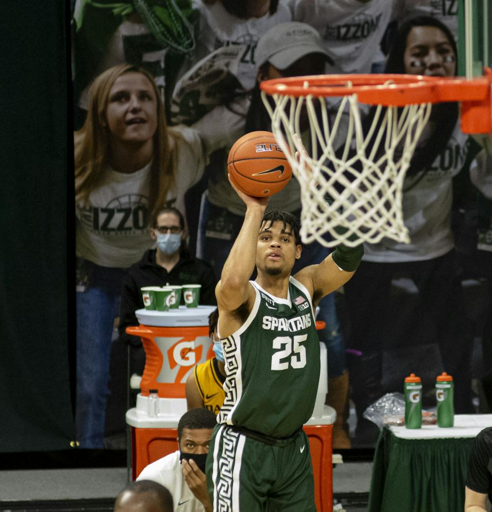 <p>Sophomore forward Malik Hall (25) lines up a shot towards the end of the first half to score against Oakland. The Spartans came back after the first half to pull out a 109-91 win on Dec. 13, 2020.</p>