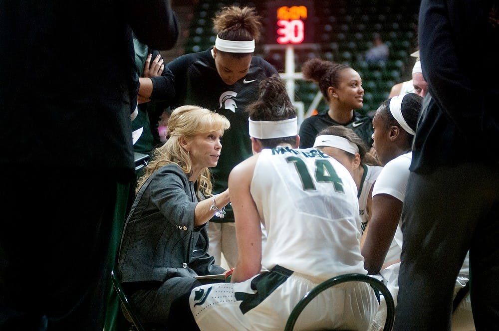 <p>Head coach Suzy Merchant talks to her players Nov. 16, 2014, during a timeout against Eastern Michigan at Breslin Center. The Spartans defeated the Eagles, 69-61. Jessalyn Tamez/The State News</p>