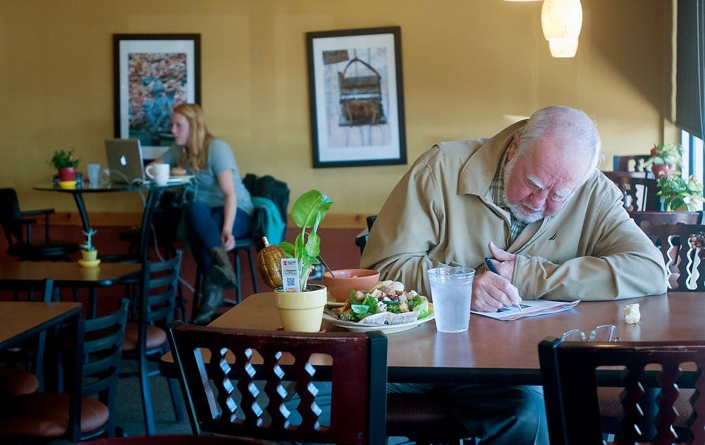 <p>Okemos, Mich., resident Tony Bauer eats lunch on Sept. 24, 2014 at the Red Cedar Cafe located on 1331 E Grand River Ave. Bauer, a regular customer, said "it's a nice comfortable place, with good food." Jessalyn Tamez/The State News</p>