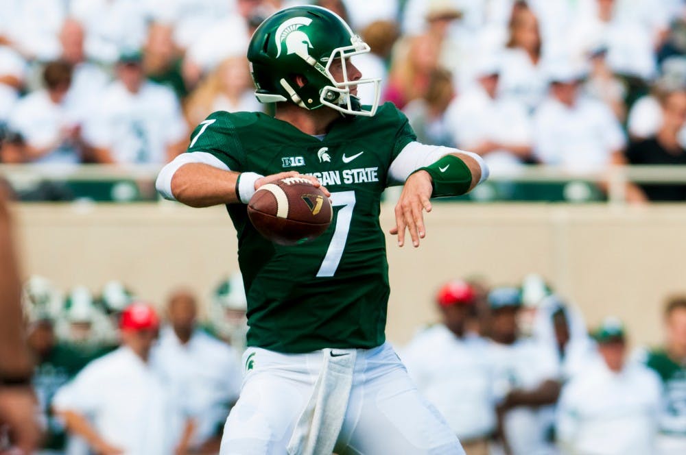 Senior quarterback Tyler O'Connor (7) prepares to throw the ball during the game against Wisconsin on Sept. 24, 2016 at Spartan Stadium.  The Spartans were defeated by the Badgers, 30-6. 