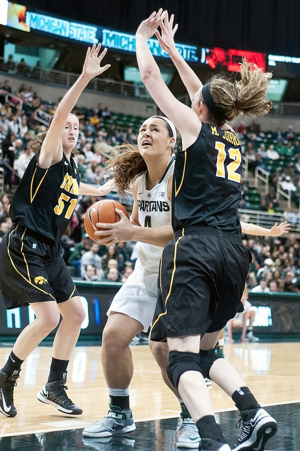 	<p>Sophomore center Jasmine Hines tries to shoot between Iowa center Morgan Johnson, 12, and Bethany Doolittle, 51, on Jan. 17, 2013, at the Breslin Center. The Spartans beat the Hawkeyes, 65-54. Julia Nagy/The State News</p>