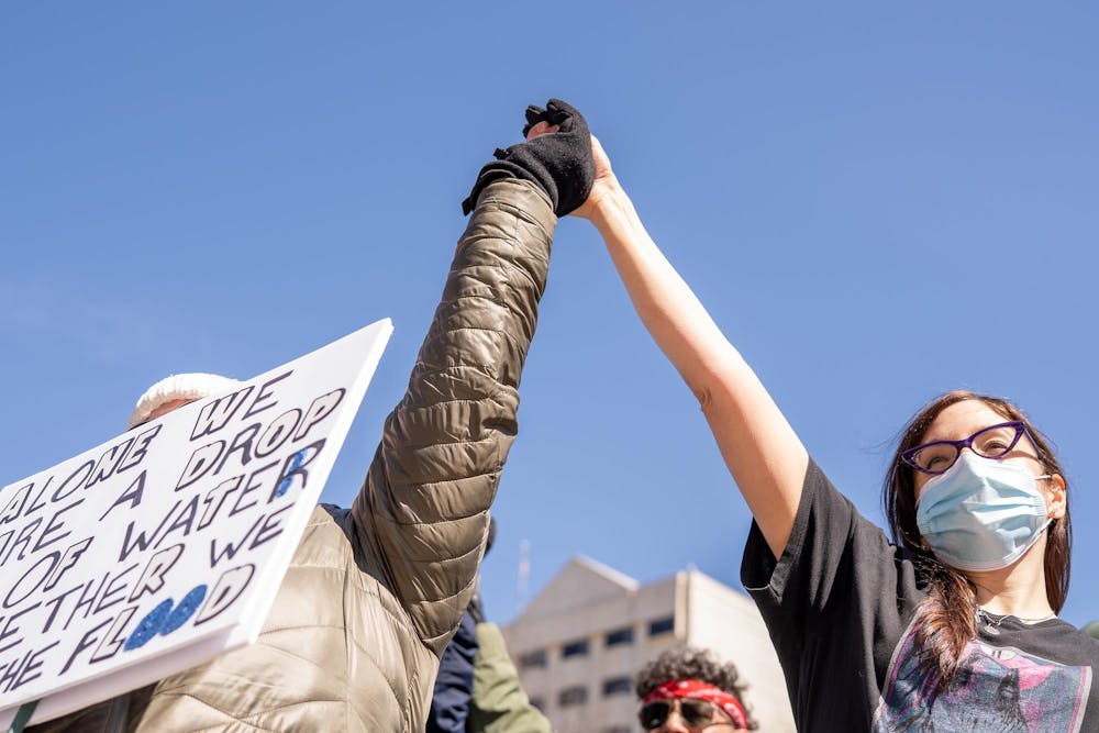 <p>Two protestors hold hands during the No Kings Protest at the Michigan State Capitol in Lansing, MI on March 28, 2026.</p>
