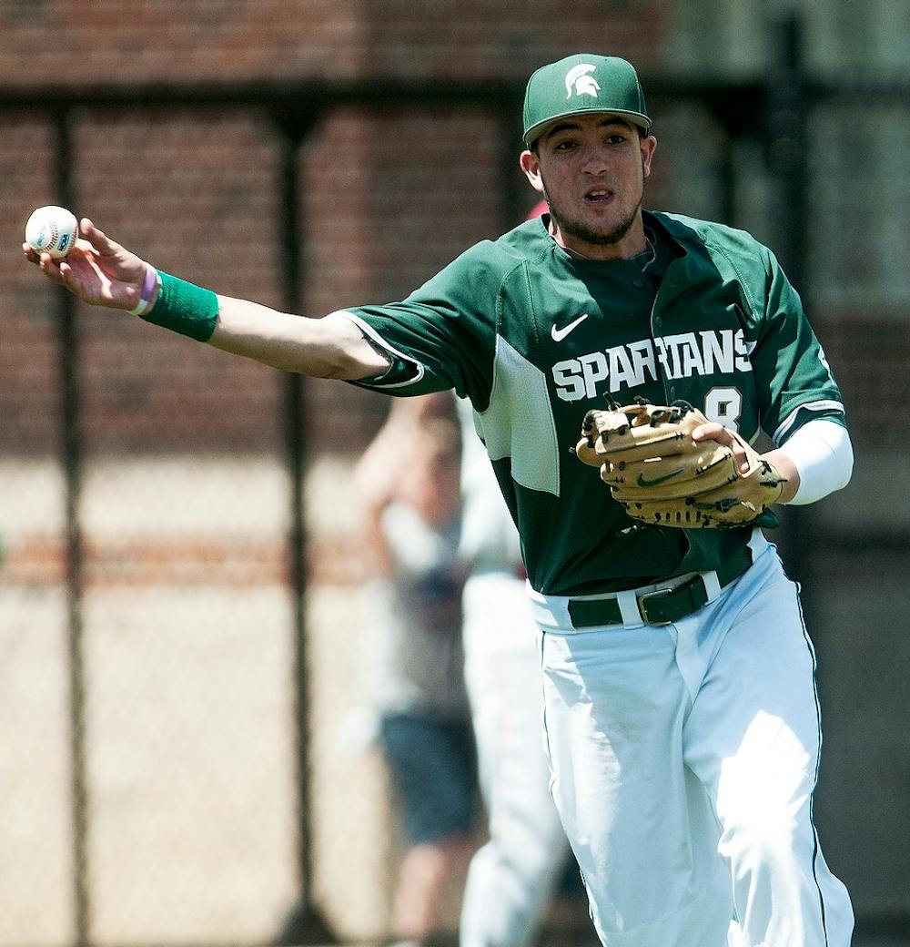 <p>Sophomore third baseman Justin Hovis throws the ball to first during the game against Nebraska on May 11, 2014, at McLane Baseball Stadium at Old College Field. The Cornhuskers defeated the Spartans, 4-1. Danyelle Morrow/The State News</p>