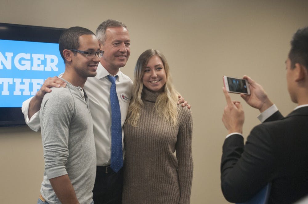 From left, Flint resident Spencer Verhagen, Governor Martin O'Malley, and political theory and social policy senior Miranda Bargert pose for a photo on Oct. 1, 2016 in the Union. O'Malley took photos with students after answering questions from students and press.