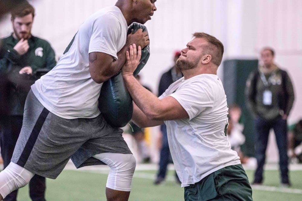 Offensive lineman Brian Allen does his position specific drills at MSU's pro day on March on March 23, 2018 at the Duffy Daugherty Football Building. MSU worked out five players at the pro day.