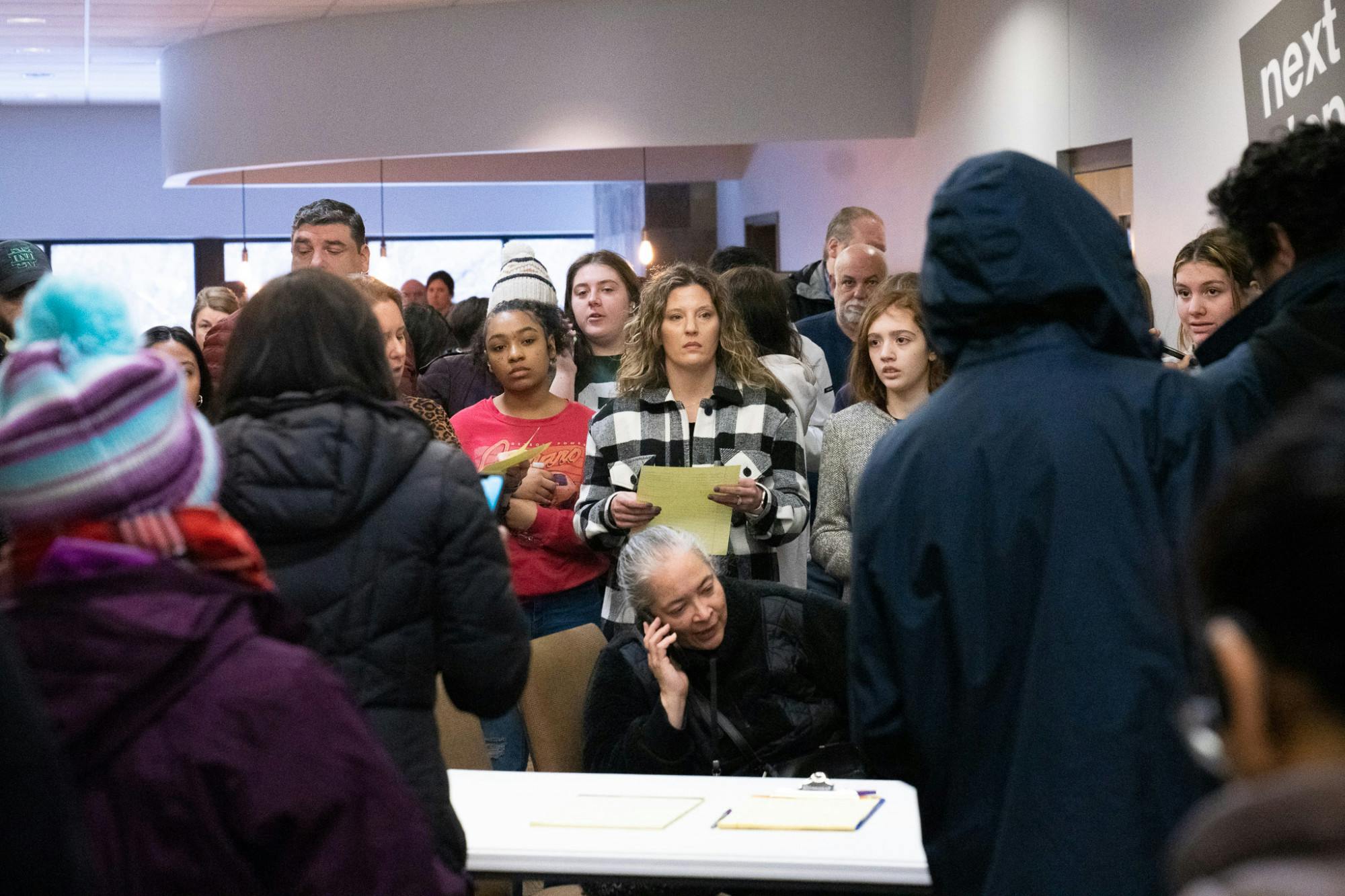 <p>Frustrated parents wait instructions to pick up their children at the 242 Community Church in Okemos after a false shooting report at Okemos High School on Feb. 7, 2023.</p>