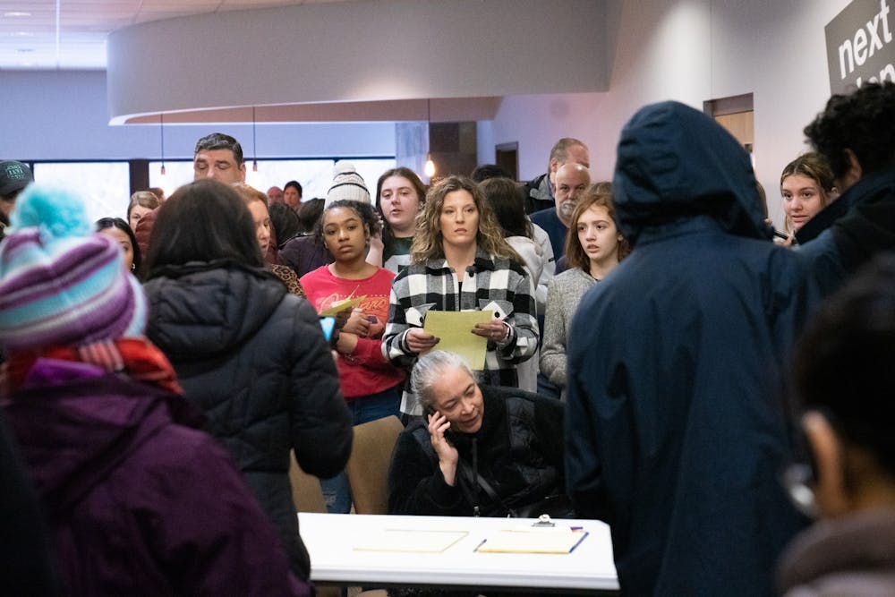 <p>Frustrated parents wait instructions to pick up their children at the 242 Community Church in Okemos after a false shooting report at Okemos High School on Feb. 7, 2023.</p>