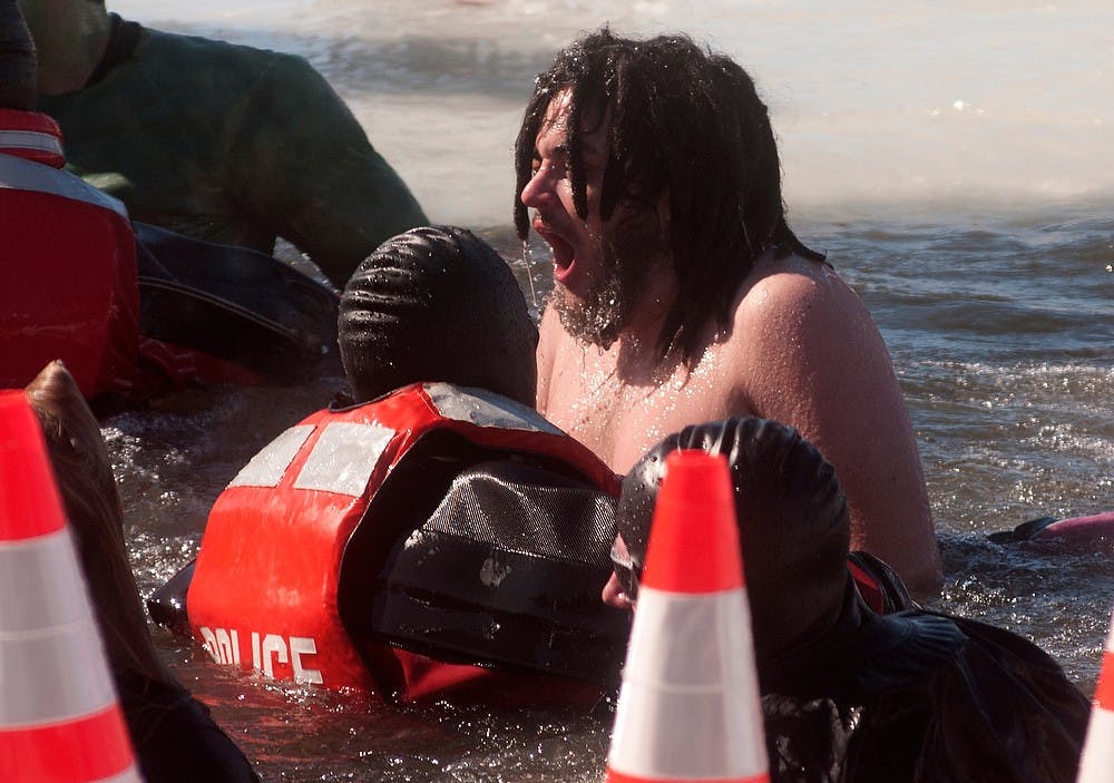 	<p>History junior Antoine Helou reacts to the cold water Sunday at Eagle Eye Golf Club during the Lansing Polar Plunge. The Lansing Polar Plunge raises money for the Special Olympics of Michigan. Betsy Agosta/The State News</p>