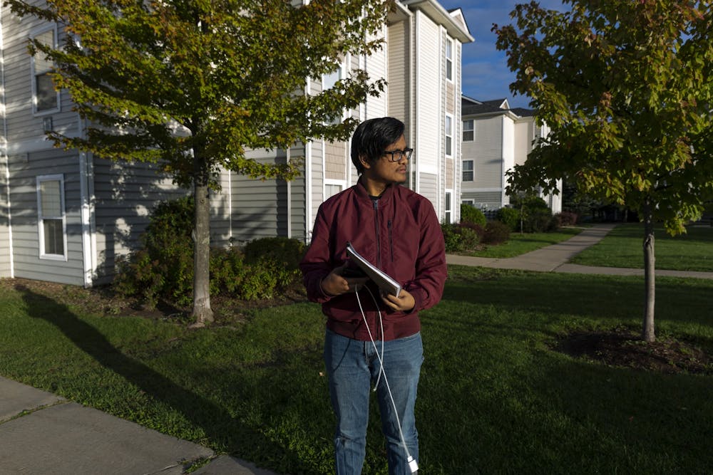 Mathematics senior Zafri Halim waits for an Uber outside of his apartment around 8:30 A.M. on Saturday, Oct. 5., 2019 in East Lansing. 