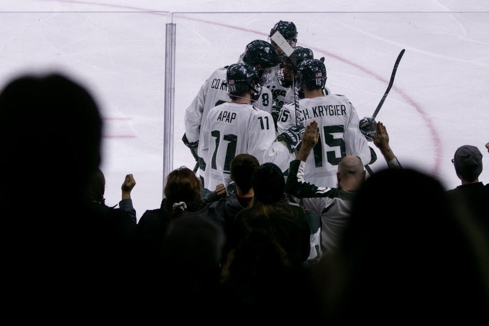 <p>The Spartans celebrate a goal during the game against Western Ontario at Munn Ice Arena Oct. 7, 2019. The Spartans defeated the Mustangs, 6-1.</p>