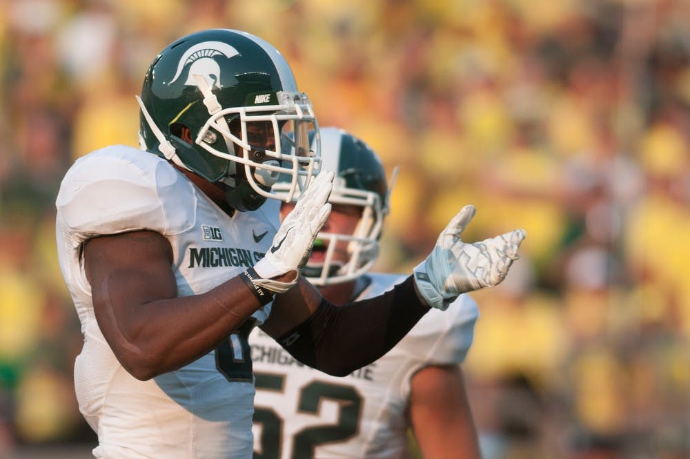 <p>Then-senior linebacker Mylan Hicks celebrates a tackle during the game against Oregon on Sept. 6, 2014, at Autzen Stadium in Eugene, Ore. The Spartans lost to the Ducks, 46-27. Julia Nagy/The State News</p>